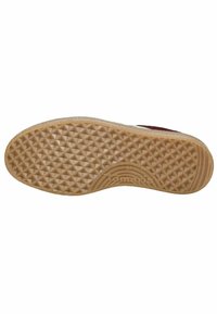 Suela de zapato de goma marrón con un patrón texturizado de diamante, que presenta una forma redondeada y un logo de la marca en relieve cerca del arco.