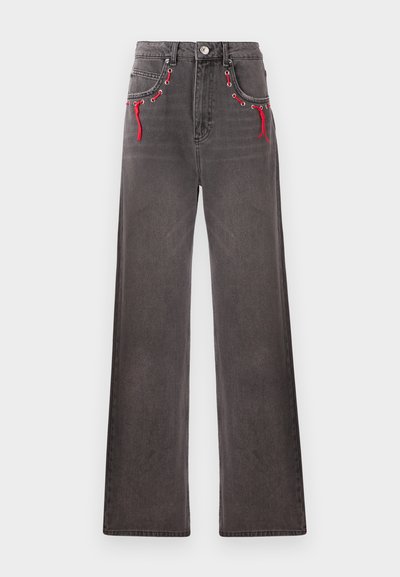 Wide-leg, high-waisted jeans in faded black denim with red laces and metal grommets on front pockets. Features classic button and zip closure.
