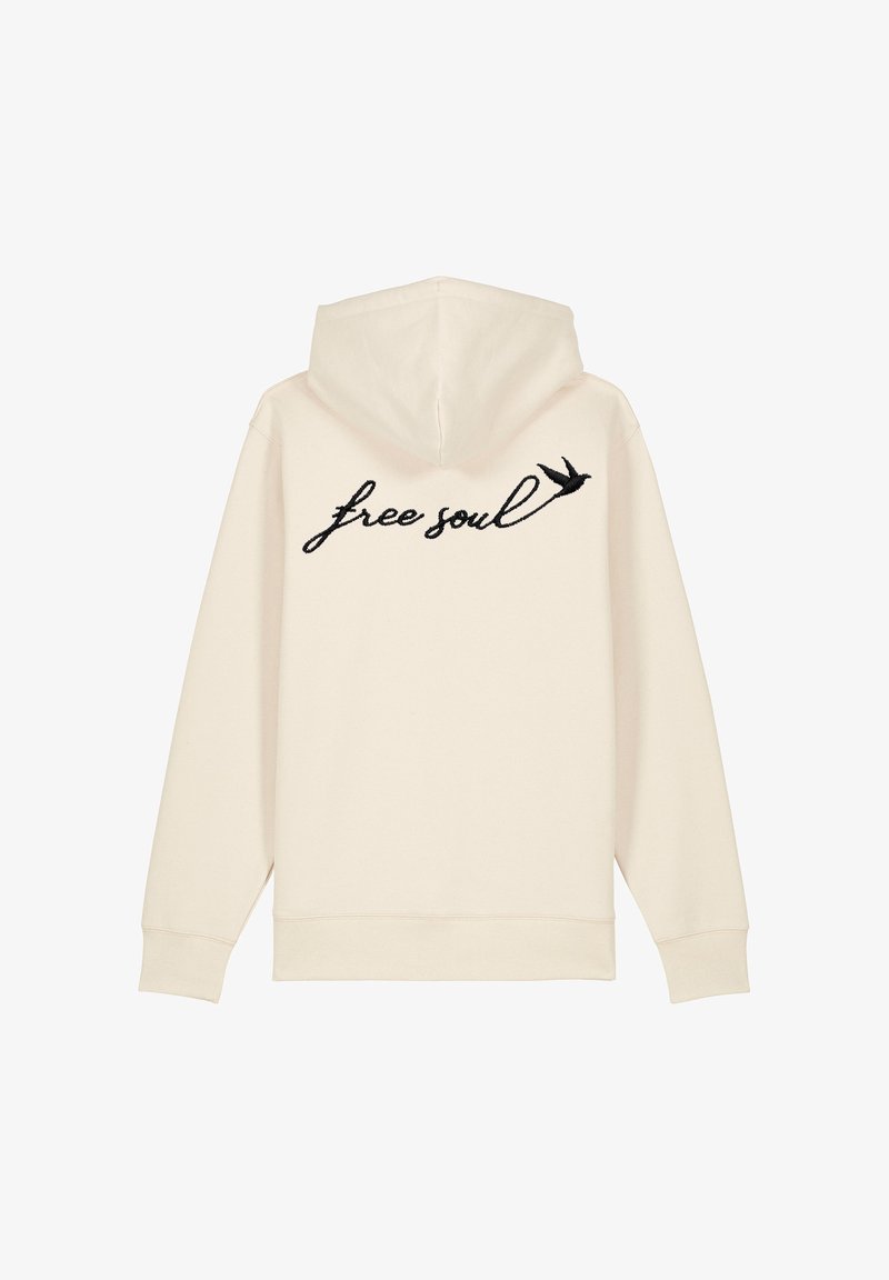 Felpa color crema con frase nera ricamata "free soul" e un piccolo design di un uccellino nero sulla schiena. Tessuto liscio, vestibilità regolare.