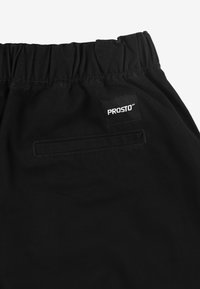 Czarne szorty z elastycznym paskiem w talii, z tylną kieszenią i kwadratową naszywką PROSTO® wszytą z tyłu. Gładka tekstura materiału.