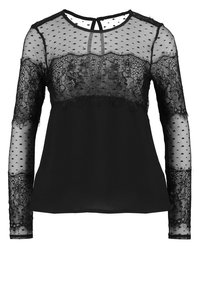 Schwarze Bluse mit langen Ärmeln aus transparentem gepunktetem Stoff und Spitze an Oberteil und Ärmeln. Rundhalsausschnitt mit Schlüssellochdetail am Rücken.