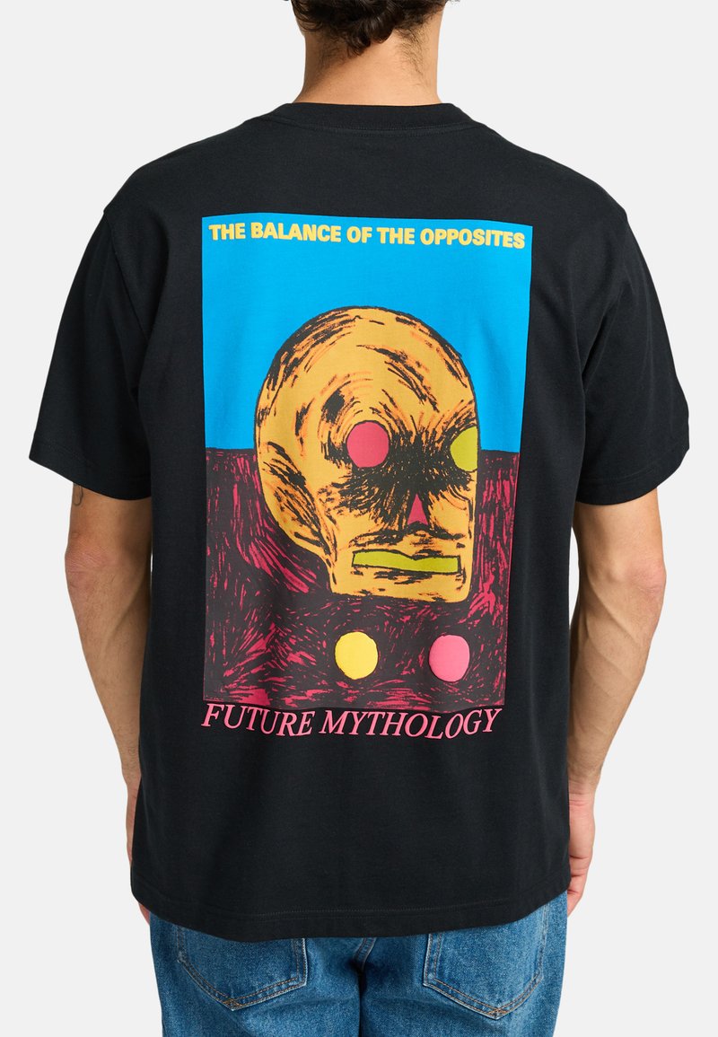 Black t-shirt featuring a graphic print of a skull with yellow and colored dots, text at top and bottom in bold pink and blue.