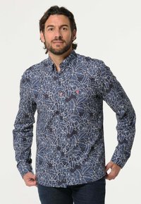 Langarm overhemd van marineblauwe stof met een wit bloemenpatroon. Beschikt over een button-down kraag en een logo detail op de borst.