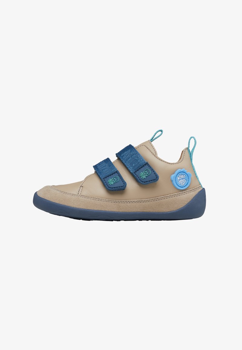 Beige children's shoe with two blue Velcro straps, teal accents, and a rubber sole. Features a round blue logo on the side.