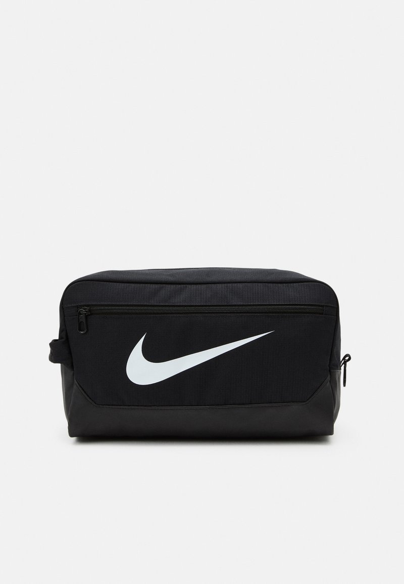 Black Nike toiletry bag with a smooth texture, featuring a white swoosh logo, top zip closure, and a side pocket.