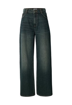 Wide-leg jeans in dark blue denim. Features a high waist, front pockets, and subtle light fading. Stitching is visible along the edges.