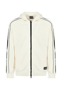 Felpa bianca con zip, strisce nere sui lati, cappuccio con cordini e patch con logo. Tessuto morbido e polsini e orlo a costine.