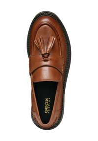 Mocassino in pelle marrone con un accento a nappina sollevato, soletta imbottita e suola in gomma nera a contrasto. Branding Geox Respira visibile all'interno.