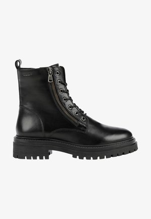 Black leather ankle boot with a rounded toe, lace-up front, side zipper, and ribbed rubber sole for traction. Features a smooth, textured finish.