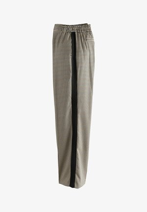 Black and white checkered pants with a relaxed fit, featuring an elastic waistband and a solid black vertical stripe down each side.