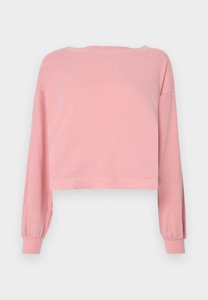 Lys rosa kuttet langermet skjorte med bred hals, ribbede mansjetter og mykt bomullsmateriale. Glatt tekstur med minimale designdetaljer.