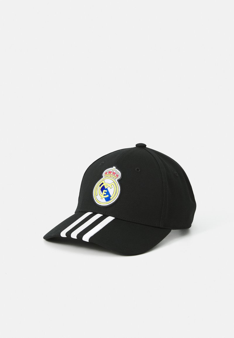 Casquette de baseball noire avec des rayures blanches sur le visière, arborant un logo rond brodé du Real Madrid à l'avant. Matière en coton.