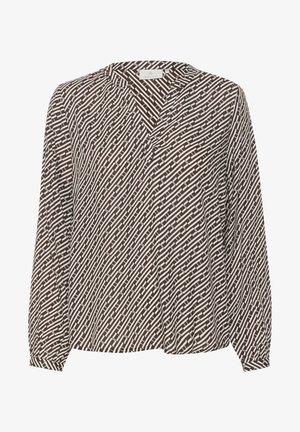 Ruda ir balta raštuota palaidinė su V formos kaklu, ilgomis rankovėmis ir laisvu siluetu. Audinys yra papuoštas tekstūriniu geometriniu raštu.