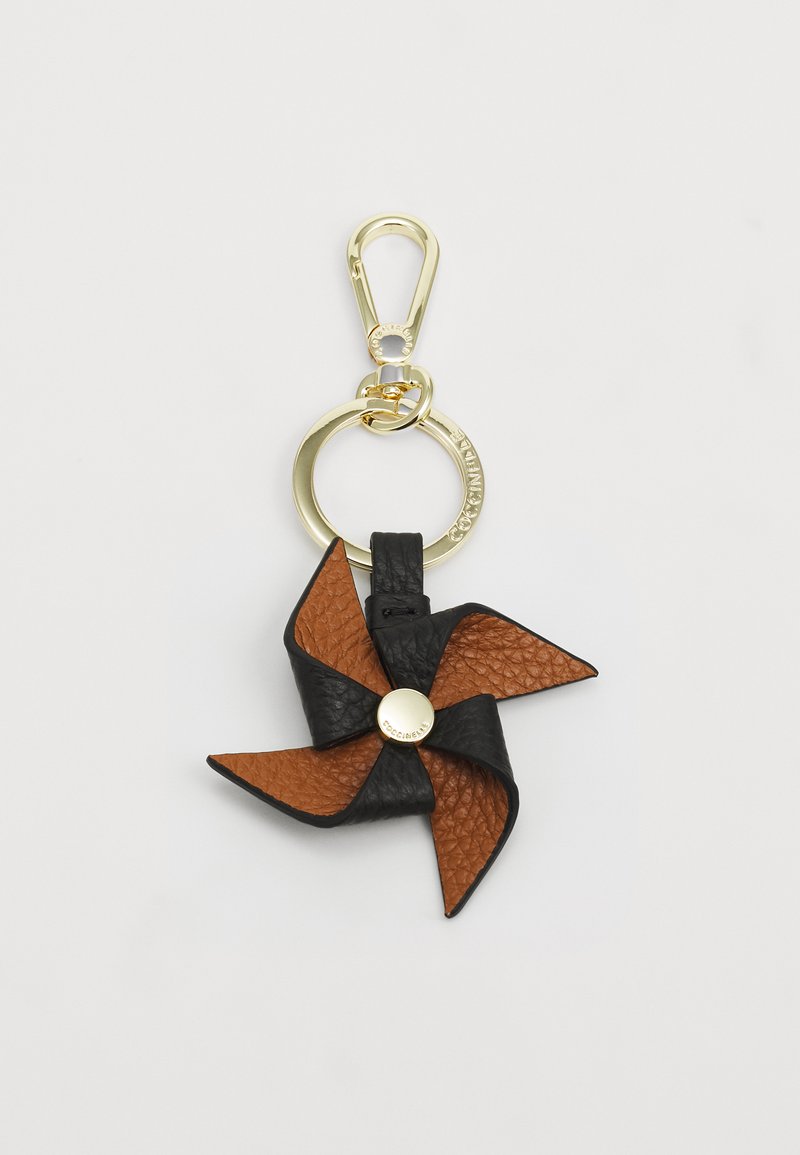 Leather keychain in black and brown colors; pinwheel design with textured surfaces and a gold-tone circular hardware accent.