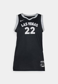 Maillot de basket noir avec "LAS VEGAS" et le numéro "22" en blanc. Fabriqué en tissu en maille, il présente des bordures grises et une étiquette sur l'ourlet.