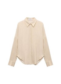 Beige long-sleeve shirt with a pointed collar, loose fit, and rounded hem. Made from a lightweight, textured fabric. Buttoned front and cuffs.