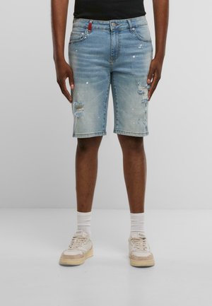 Jeansshorts in hellblau mit destruktiven Details und Farbspritzern. Fünf-Taschen-Design mit Reißverschluss und Knopfverschluss.