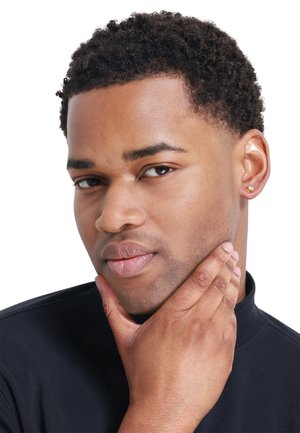 Gold stud earring with diamond accent on right ear; short, textured black hair; smooth skin; wearing a black turtleneck.