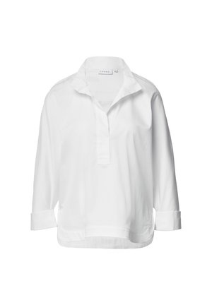 Camicia bianca, svolazzante, con colletto, maniche lunghe ripiegate ai polsini e mezza abbottonatura, realizzata in tessuto morbido.