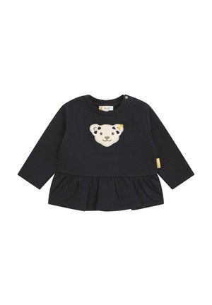 Maglietta a maniche lunghe blu navy con un'applicazione testurizzata di un volto d'orso e un orlo arricciato. Presenta bottoni sulle spalle e un'etichetta sul lato.