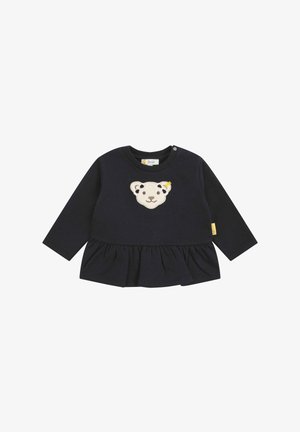 Maglietta a maniche lunghe blu navy con un'applicazione testurizzata di un volto d'orso e un orlo arricciato. Presenta bottoni sulle spalle e un'etichetta sul lato.