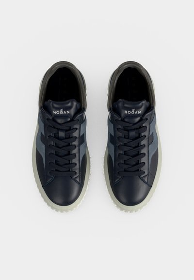 Paire de baskets Hogan bleu marine avec semelles blanches et lacets noirs vues de dessus sur fond blanc.