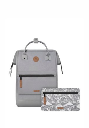 Gray fabric backpack with top handle, front zipper pocket, and leather accents. Includes a smaller palm-patterned pouch.