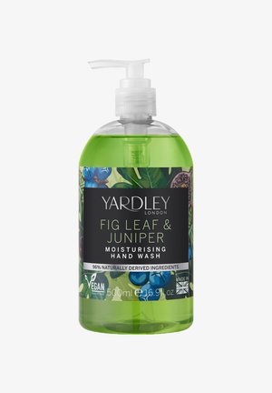 Grüne Flüssigseife in einer klaren 500 ml Pumpflasche. Mit floralem Design, schwarzem Etikett und den Hinweisen "vegan" und "made in UK."