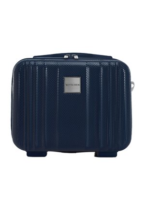 Navy hard-shell luggage with textured surface, vertical ridges, metal logo plate, and a top zipper. Compact rectangular shape with four feet.