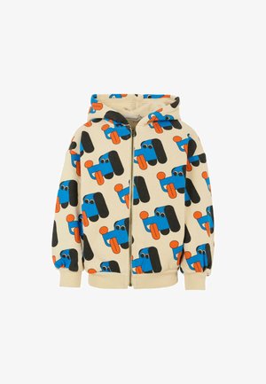 Sudadera con cremallera beige que presenta un divertido estampado de perros de dibujos animados en azul y naranja, con grandes acentos negros y ojos expresivos.