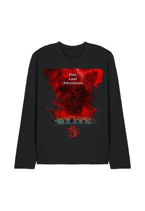 Black long-sleeve shirt with red storm clouds and lightning, shadowy monster face, people riding bikes, text "One Last Adventure," and Stranger Things 3 logo.