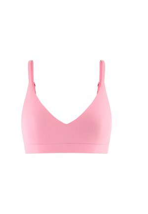 Soutien-gorge sans fil rose pâle avec des bretelles fines réglables et un design lisse et sans couture, présenté sur un fond blanc.