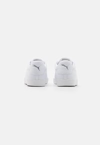 Vita sneakers i slätt syntetmaterial, rund tå, vadderad krage och silverfärgade logotypdetaljer på hälen och sidorna. Platt gummisula.