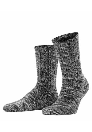 Gestrickte Socken in einem schwarz-grauen Melange-Muster, mit gerippter Textur und Knöchelhöhe für zusätzlichen Wärme- und Tragekomfort.
