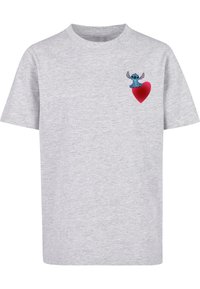 Harmaa puuvillapaita, jossa on lyhyet hihat. Paidassa on vasemmassa rintakehässä sininen sarjakuvahahmo istumassa punaisella sydämellä.