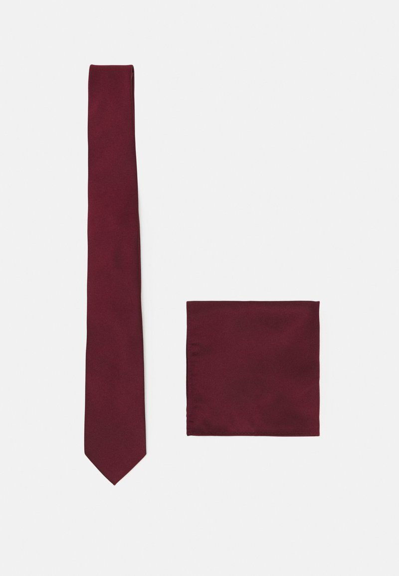 Burgundy silk tie with a smooth texture, narrow design, and pointed tip alongside a matching pocket square in a square format.