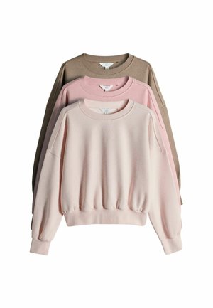 Three long-sleeve crewneck sweatshirts stacked, colors from front to back: light pink, muted pink, and beige.