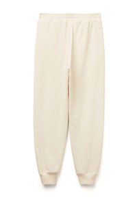 Beżowe spodnie dresowe z elastycznym pasem i mankietami. Wykonane z miękkiego, gładkiego materiału, o luźnym, zwężanym kroju.
