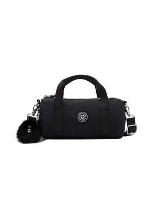 Petit sac à main cylindrique noir avec deux poignées, bandoulière réglable, logo Kipling et un porte-clés rond noir et duveteux attaché.