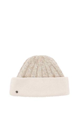 Beige knitted winter hat with a soft, fluffy fold-over brim and a small round metal logo on the brim’s left side.