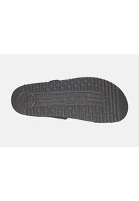 Semelle de sandale en caoutchouc noir avec une texture antidérapante, des motifs en relief et un texte en relief, conçue pour le confort et la stimulation par réflexologie.