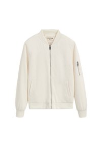 Veste bomber couleur crème avec une texture douce en chevron, fermeture éclair à l'avant, poignets côtelés, et deux poches latérales, dont une avec une fermeture éclair.