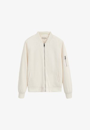 Veste bomber couleur crème avec une texture douce en chevron, fermeture éclair à l'avant, poignets côtelés, et deux poches latérales, dont une avec une fermeture éclair.