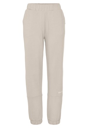 Lysebeige joggingbukser med elastisk talje, sidelommer og elastiske manchetter, med lille hvid tekst på det nederste højre ben.