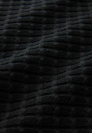 Black knitted fabric featuring a textured, grid-like pattern, with raised squares providing depth and a soft, tactile appearance.