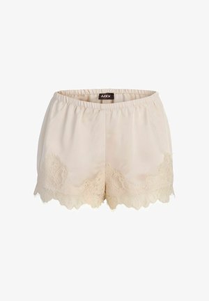 Pantalones cortos de satén color crema con cintura elástica y adornos de encaje en el dobladillo, etiquetados como JJXX en el interior de la cintura.