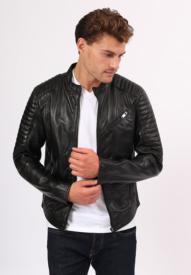 Giacca di pelle nera con dettagli trapuntati sulle spalle e una tasca sul petto con zip; presenta una vestibilità slim e una texture liscia.