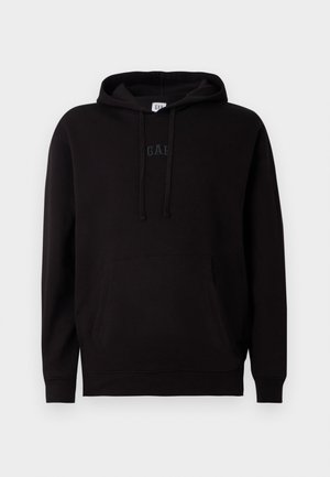 Black hoodie with a kangaroo pocket, drawstring hood, and raised "GAP" logo in the center. Made of soft fabric, featuring ribbed cuffs and hem.