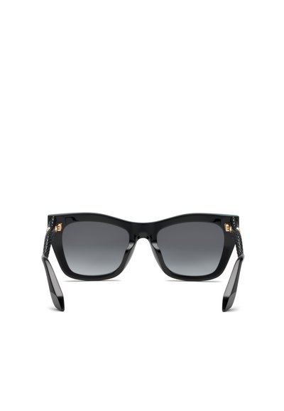 Lunettes de soleil noires à monture carrée avec verres foncés dégradés et branches texturées avec petits détails dorés aux charnières.
