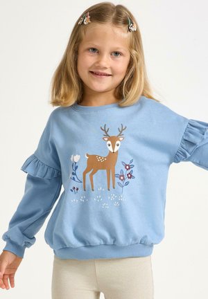 Sweatshirt bleu clair avec des manches volantes, mettant en avant un graphisme de cerf brun entouré de fleurs. Mélange de coton doux, poignets et ourlet côtelés.